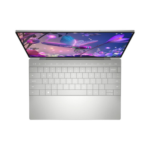 A silver Dell XPS 13 Plus 9320 laptop, seen from above with its OLED touchscreen open and displaying a vibrant butterfly and flowers. The sleek, minimalist design features a visible keyboard. Specs: i7-1260P, 16GB RAM, 512GB SSD, 13.3" Touch.