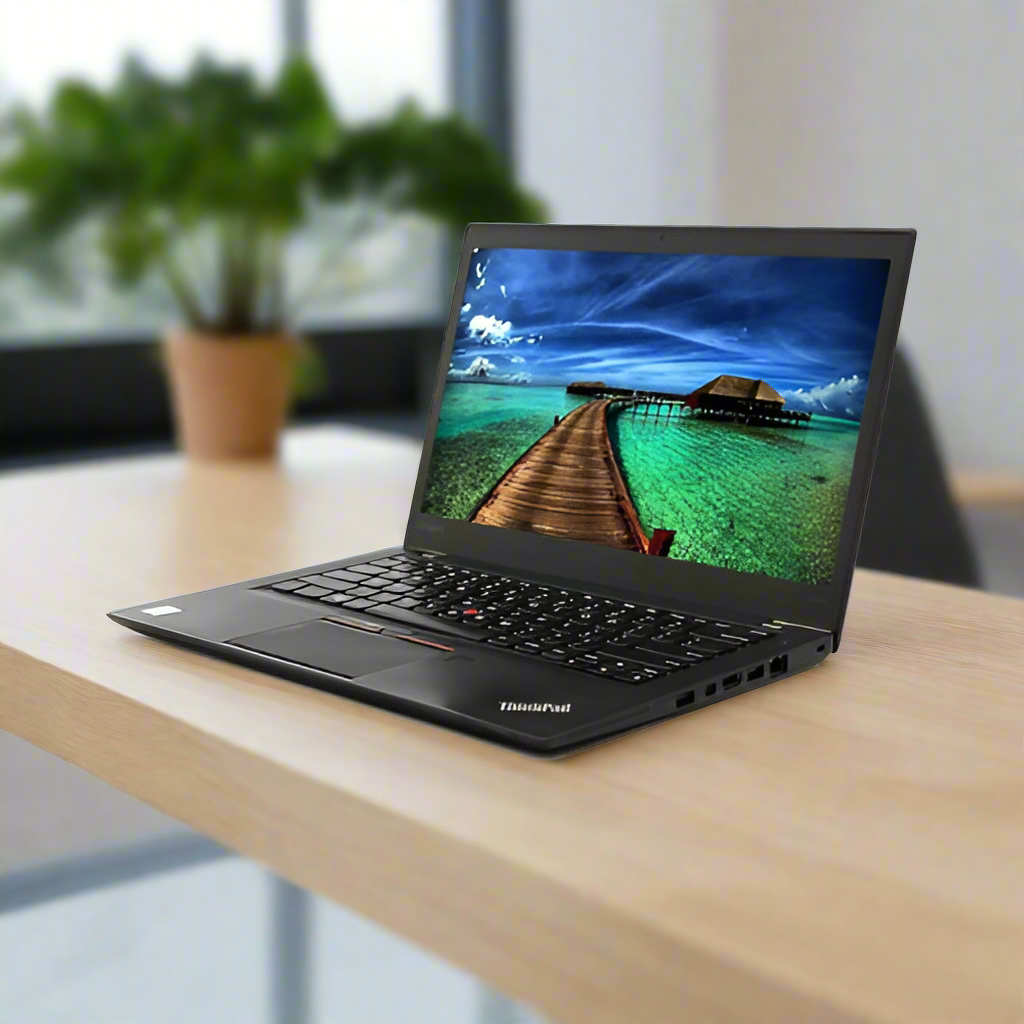 A Lenovo ThinkPad T460s (i7 6600U, 8GB RAM, 256GB SSD, Win10 Pro, 14 Touch) certified refurbished laptop sits on a wooden desk, displaying a tropical beach scene. A potted plant and large window are blurred in the background.