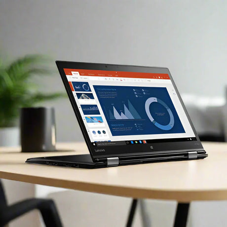 A Lenovo ThinkPad X1 Yoga i5 6300U 2.4GHz 8GB 256GB SSD Touch 14 W10P sits open on a light-colored desk, displaying charts and graphs, with a blurred green plant and a cup visible in the background.