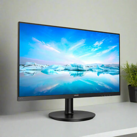 A Philips 241V8 23.8" IPS 1920x1080 monitor sits on a white desk, displaying icebergs and blue sky over water. A green potted plant is visible in the background to the right.