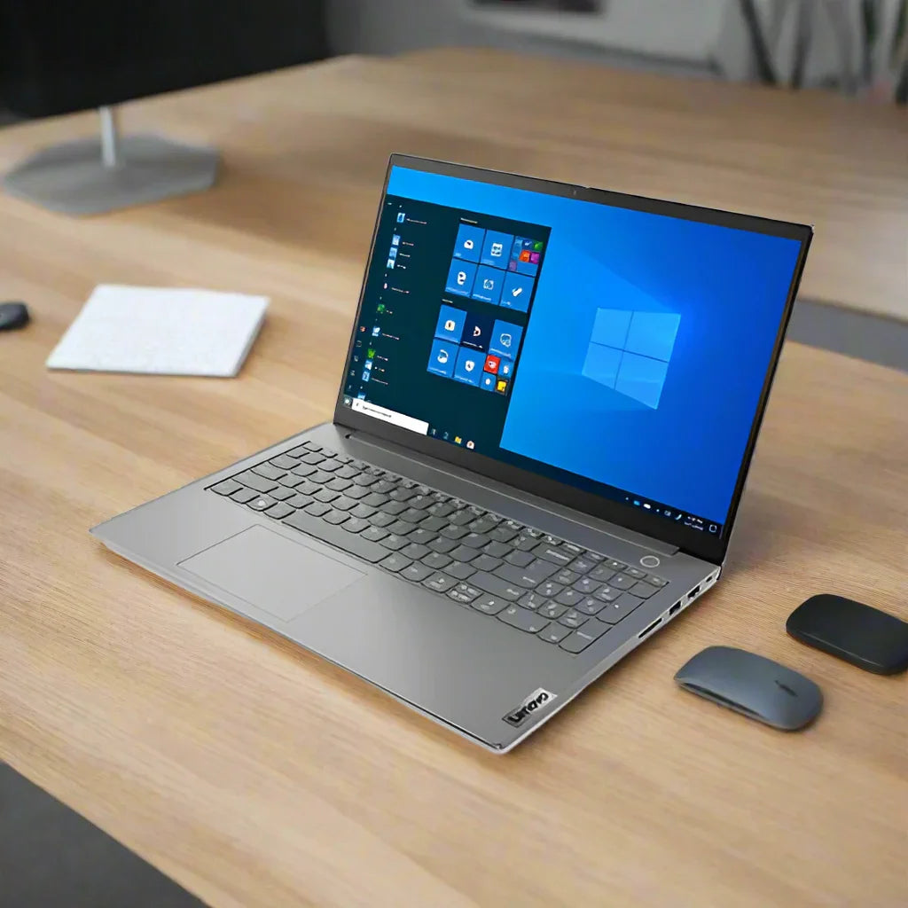 A silver Certified Refurbished Lenovo ThinkBook 14s G2 with Intel Core i5, 16GB RAM, and 512GB SSD displays Windows on a wooden desk beside a wireless mouse, closed black case, and white keyboard.