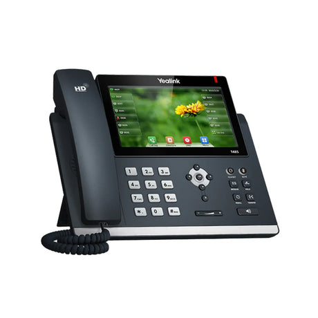 The Yealink SIP-T46S Gigabit IP Phone + Adapter | Wty features a color touchscreen, physical keypad, and left-side handset—angled right with a coiled cord—ideal for efficient business communication from Yealink.