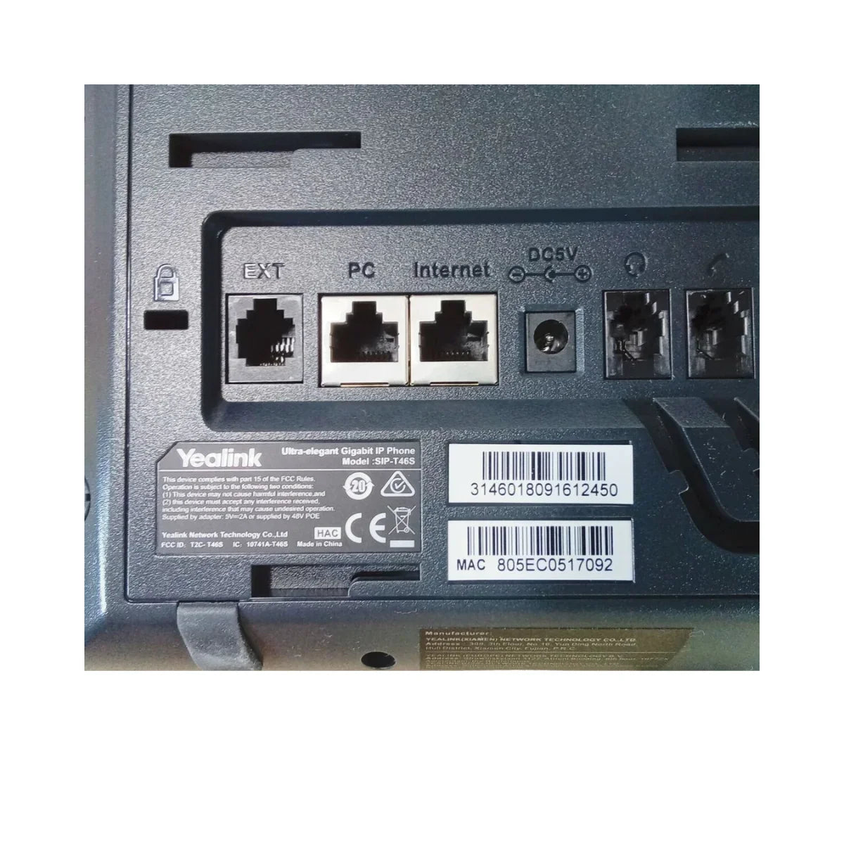 Close-up of the Yealink SIP-T46S Gigabit IP Phone + Adapter | Wty back panel, showing ports labeled EXT, PC, Internet, and DC5V, plus a barcode, serial number, and MAC address—perfect for Yealink business communication setups.