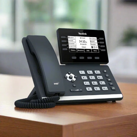 A brand new Yealink SIP-T53W WIFI + Bluetooth IP phone with a 3.7 LCD sits on a wooden surface in a bright office, featuring dual-band Wi-Fi and Bluetooth for enhanced connectivity.