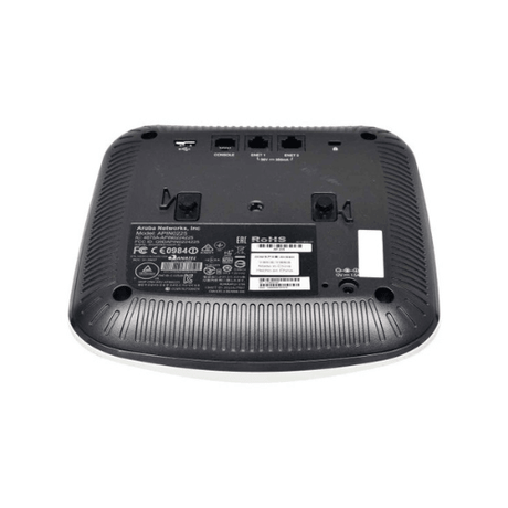 The image shows the underside of a black Aruba AP-225 Dual Radio 802.11ac Wireless Access Point, displaying various ports, indicator stickers, certifications, and ventilation slots for dual-band Wi-Fi.