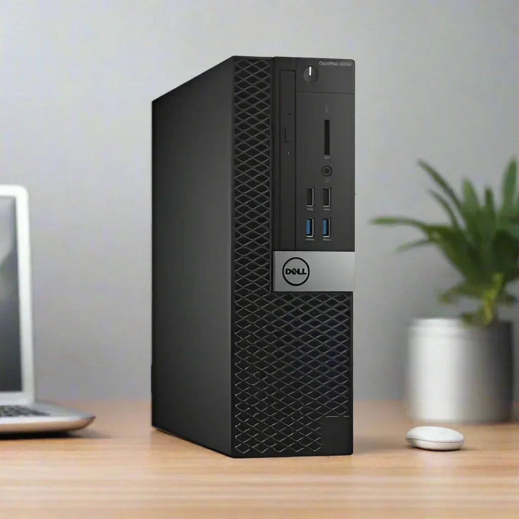 A refurbished black Dell OptiPlex 7040 SFF i5 6500 3.2GHz 8GB 256GB SSD W10P Computer stands on a desk beside a closed laptop, wireless mouse, and potted plant, set against a neutral-colored wall.