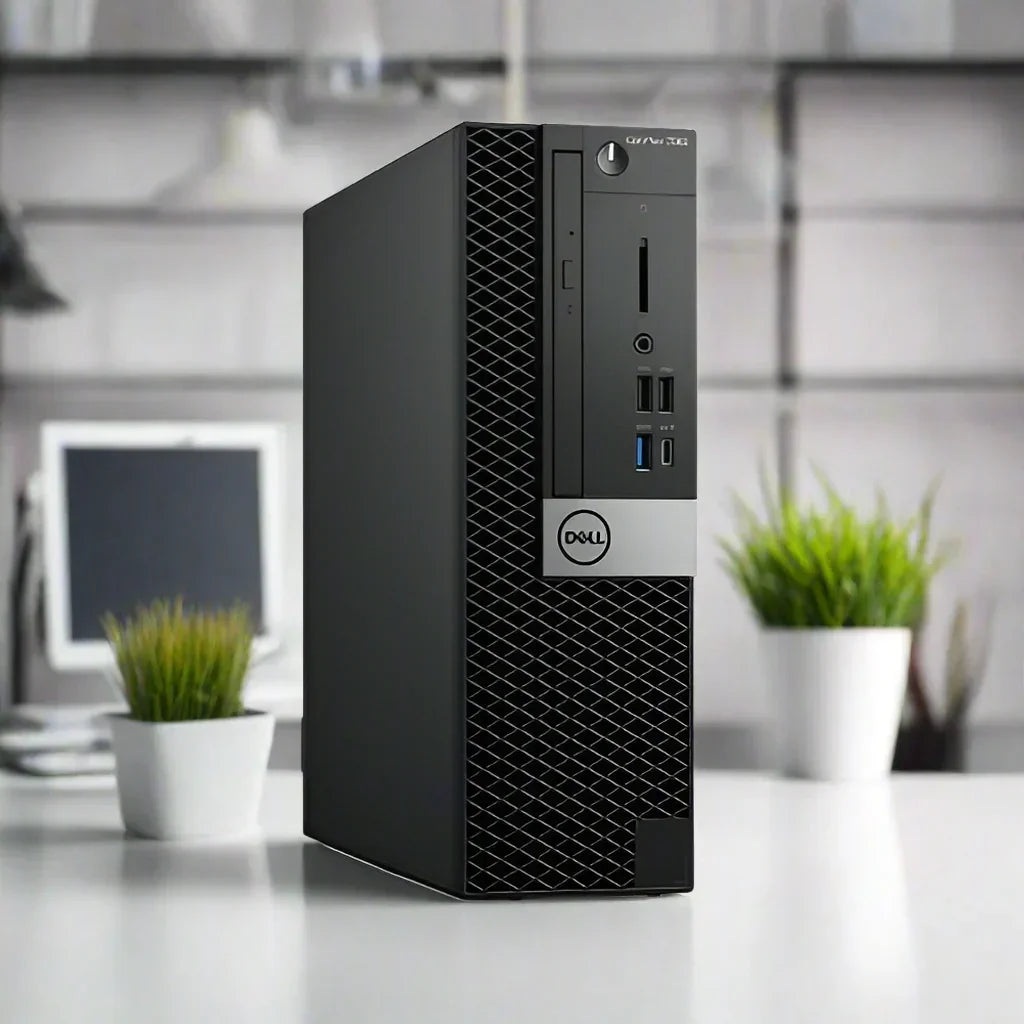 A refurbished Dell OptiPlex 7060 SFF i5 8500 PC with 8GB RAM and 256GB SSD sits on a white desk between two green potted plants, with a blurred monitor and keyboard in the background for a modern office vibe.