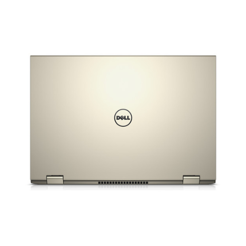 A closed gold Dell Inspiron 7359 2-in-1 i5-6200U laptop is shown from the back, displaying the Dell logo at the center and two hinges at the bottom.