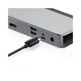 A close-up of an ALOGIC MX2 DUPRMX2 USB-C Dual Display Docks side shows HDMI, USB, USB-C, and audio ports with a USB-C cable about to connect. Ideal for linking 4K UHD displays; adapter included. Certified Refurbished.