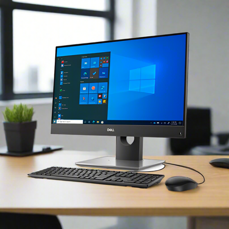 A Dell Refurbished OptiPlex 7490 AIO with 23 display, i5 11500, 16GB RAM, 512GB SSD, and Windows 11 Home is set up on a wooden desk in a modern office with keyboard, mouse, and a small plant.