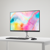 The Dell S2722DC IPS 27" QHD monitor with thin bezels and a sleek silver base displays a vibrant pastel abstract wallpaper in pink, yellow, blue, and green.