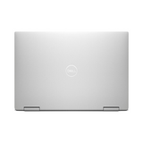A closed silver Dell XPS 13 7390 2-in-1 (i7, 16GB, 512GB SSD, 13.4 Touch), viewed from above with a centered Dell logo on the lid. The laptop shows a sleek, minimalist design and visible bottom-edge hinges.