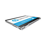 An HP Spectre x360 13-w031tu laptop is displayed in tablet mode, showcasing its sleek silver design and touchscreen with the HP logo visible on screen.