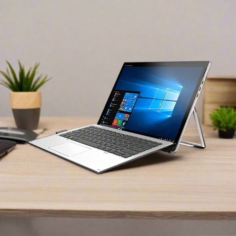 An HP Elite Tablet X2 1012 G1 with Intel M5-6Y57, 8GB RAM, and 256GB SSD sits on a wooden desk showing Windows 10 Pro. Two small potted plants and a closed notebook are in the background.