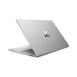 An HP ZBook Studio G9, partially open to reveal its modern silver design and prominent Z logo on the lid, is angled to show the left-side ports. This mobile workstation features an i7-12800H CPU, 64GB RAM, 1TB SSD, and RTX 3070 graphics.