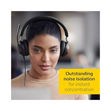 A woman wearing a Jabra Evolve2 40 Stereo Wired Headset USB-C focuses on a screen in an office. A yellow box displays the message: “Outstanding noise isolation for instant concentration.”.