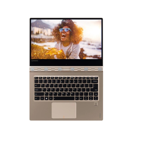 A silver Lenovo Yoga 910-13IKB laptop with a 14" 4K UHD display shows a joyful woman in sunglasses smiling, set against an outdoor backdrop.