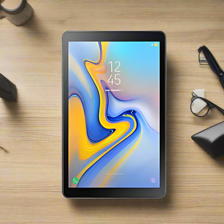 A Samsung Galaxy TAB A SM-T595 Black 32GB 10.5 Tablet by Samsung rests on a wooden desk with accessories like a pen, glasses, and cup. The vibrant display shows the time as 12:45.