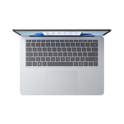 A certified refurbished Microsoft Surface Studio i7 11370H (3.3GHz, 32GB RAM, 1TB, RTX 3050, 14.4" Touch) sits on a plain white background, viewed from above with a black keyboard, large trackpad, and a partially open Windows display.