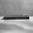 A refurbished Cisco WS-C2960X-24TD-L 24-port Gigabit switch with 2 x 10G SFP+ ports is displayed on a white surface against a plain, light gray background.