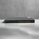 A refurbished Cisco WS-C2960X-24TD-L 24-port Gigabit switch with 2 x 10G SFP+ ports is displayed on a white surface against a plain, light gray background.