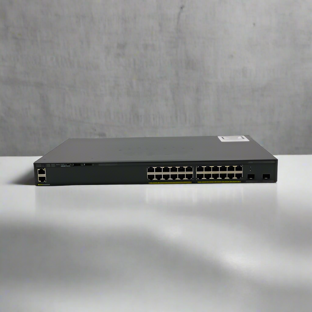 A refurbished Cisco WS-C2960X-24TD-L 24-port Gigabit switch with 2 x 10G SFP+ ports is displayed on a white surface against a plain, light gray background.