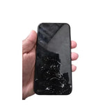 A hand holds an Apple iPhone 11 128GB Black Unlocked Smartphone with a screen cracked near the bottom, displayed against a white background.