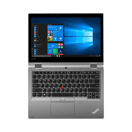 A silver Lenovo ThinkPad Yoga L390 with a 14" touchscreen is open, showing the Windows home screen. The keyboard, touchpad, and signature red TrackPoint are visible. Specs: i5 8265U, 8GB RAM, 256GB SSD, Windows 11 Home.