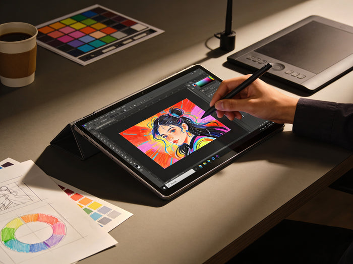 Artist using Microsoft Surface tablet with stylus pen for digital illustration